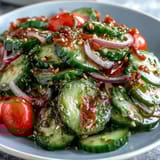 Sliced cucumbers, red onions, and fresh dill tossed in tangy vinegar dressing.
