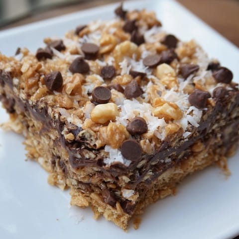 A close-up shot of gooey Hello Dolly Bars, a classic dessert with layered ingredients.