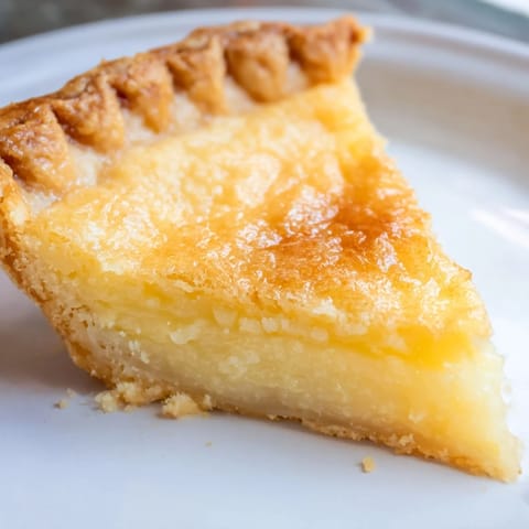 A beautiful slice of Chess Pie, showcasing the golden crust and creamy, sweet filling.