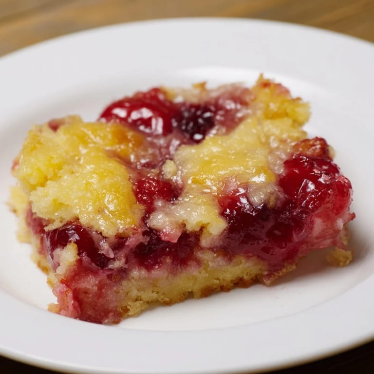 Warm, fruity cherry dump cake with golden crust, perfect for sharing at a family gathering or potluck.